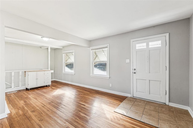 entryway featuring visible vents, baseboards, and light wood finished floors