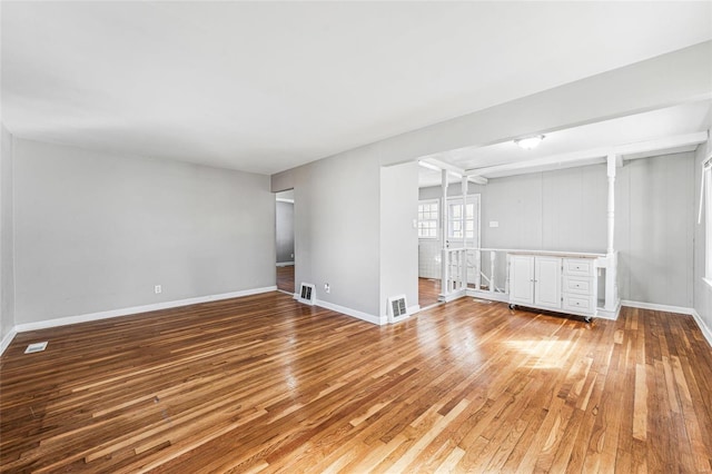 unfurnished room featuring baseboards, visible vents, and light wood-type flooring