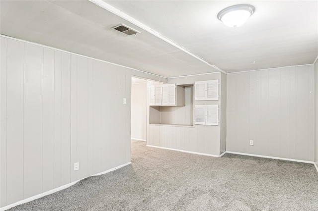 spare room with visible vents, baseboards, and carpet floors