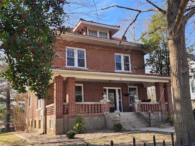 traditional style home with covered porch and brick siding