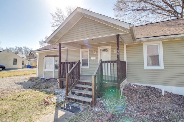 bungalow featuring a porch and a shingled roof