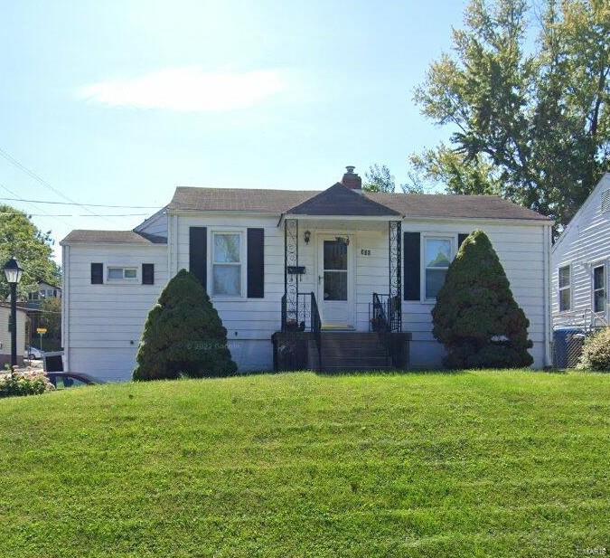 view of front of home featuring a front yard and a chimney