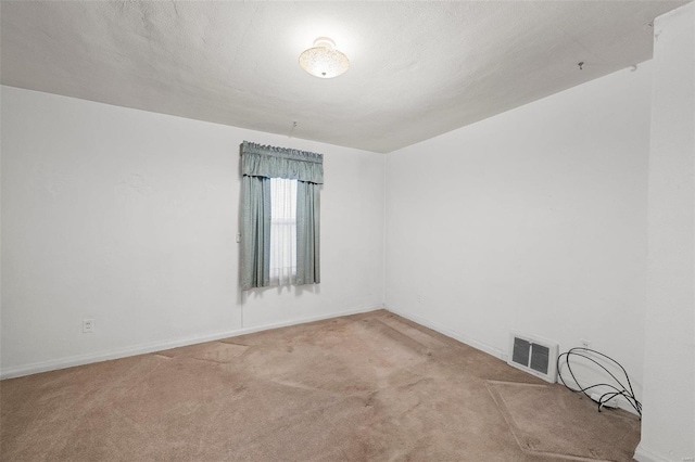 unfurnished room with carpet flooring, baseboards, and visible vents