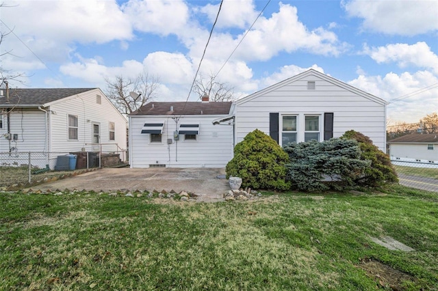 back of house with a yard, a patio, a chimney, and fence