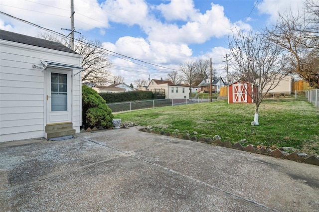 view of yard with a fenced backyard, a patio, and an outdoor structure