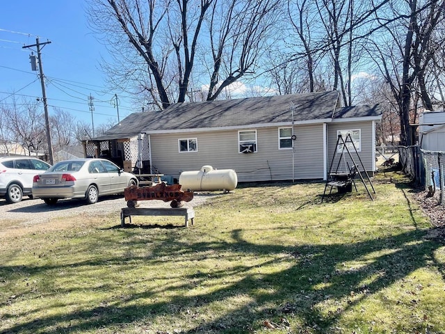 exterior space with a lawn and fence