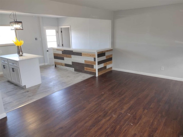 interior space with wood finished floors and baseboards