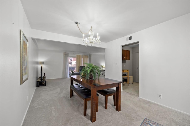 dining space featuring light carpet, baseboards, visible vents, and an inviting chandelier