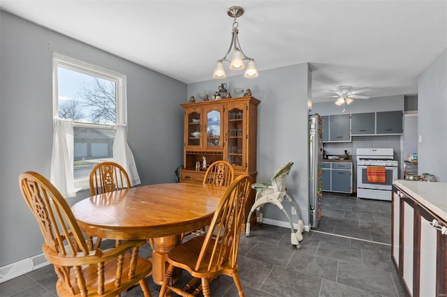 dining room featuring visible vents, ceiling fan, and baseboards