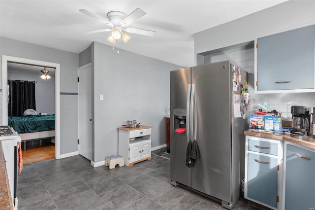 kitchen featuring a ceiling fan, baseboards, range, stainless steel fridge with ice dispenser, and tasteful backsplash