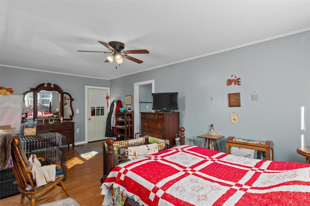 bedroom featuring ornamental molding, wood finished floors, a ceiling fan, and baseboards