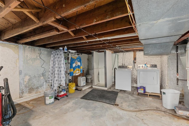 unfinished basement featuring washing machine and dryer