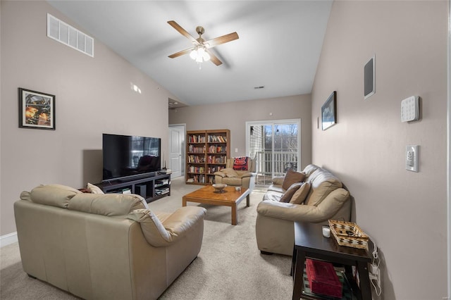 living area with visible vents, lofted ceiling, light colored carpet, and a ceiling fan