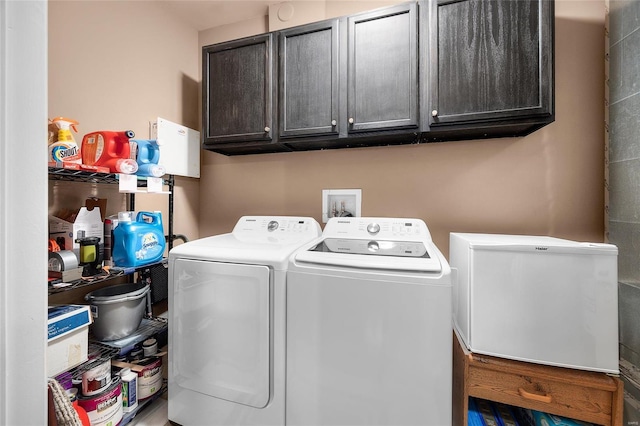 laundry room with cabinet space and separate washer and dryer