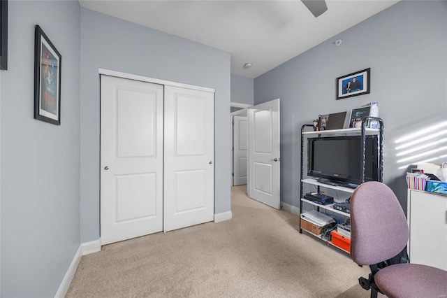 carpeted office featuring baseboards and ceiling fan