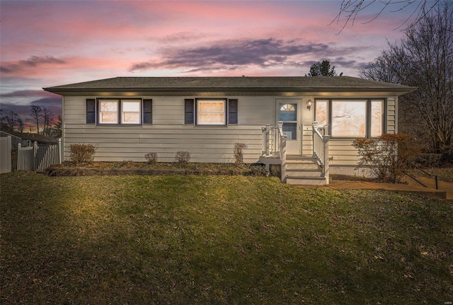 view of front of house featuring a front yard and fence