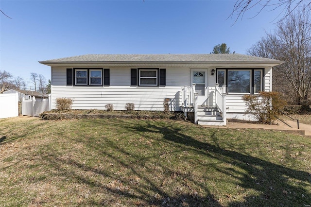 single story home featuring a front yard and fence