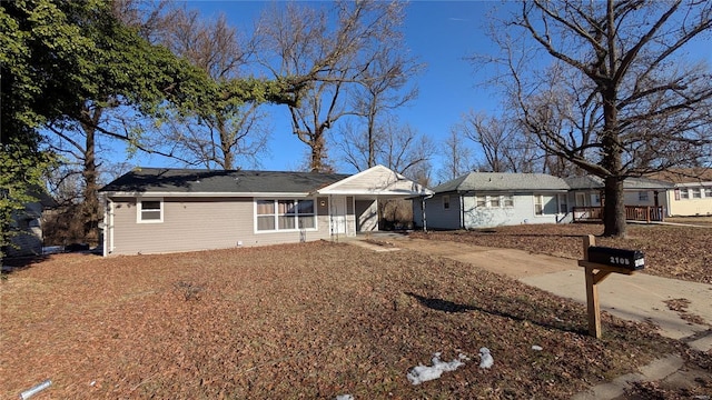 ranch-style house with an attached carport and driveway