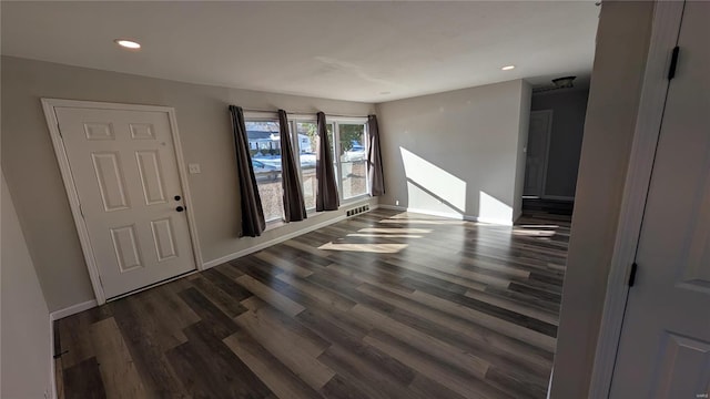 interior space featuring dark wood-style floors, recessed lighting, and baseboards