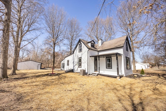 exterior space featuring a chimney, central AC unit, and a porch