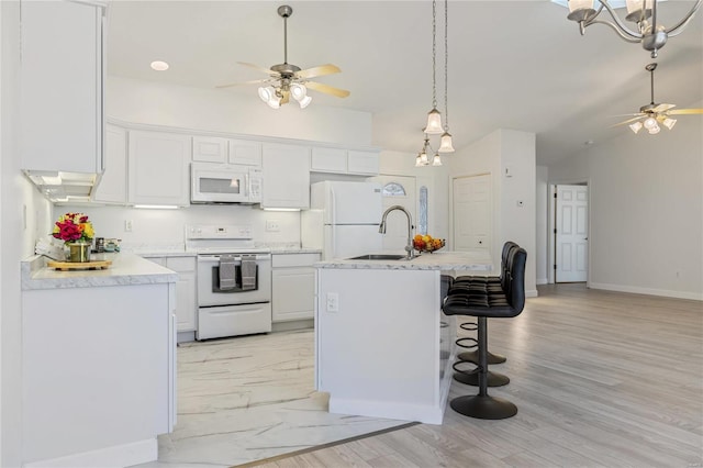 kitchen with white appliances, a sink, a ceiling fan, white cabinets, and light countertops