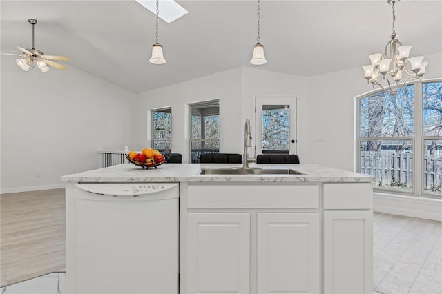 kitchen featuring white cabinetry, vaulted ceiling, white dishwasher, a sink, and light wood-type flooring