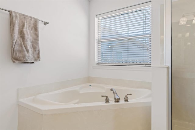 full bath with a wealth of natural light, a shower stall, and a bath