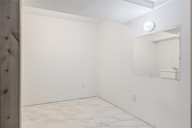 spare room with marble finish floor