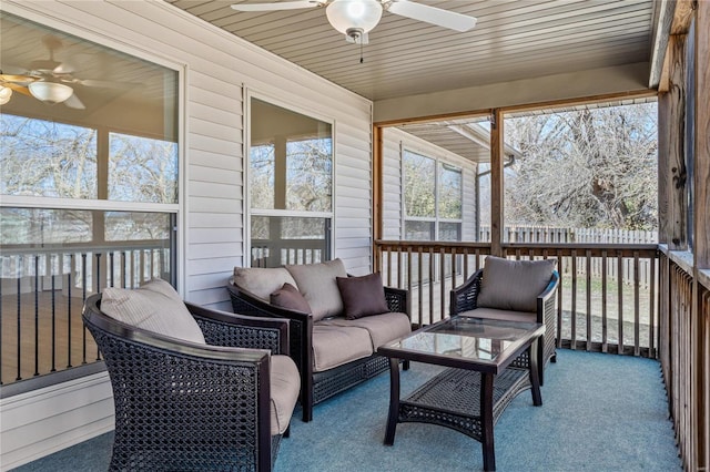 sunroom featuring ceiling fan and wooden ceiling