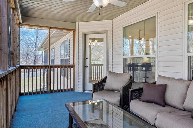 sunroom / solarium featuring wooden ceiling and a ceiling fan