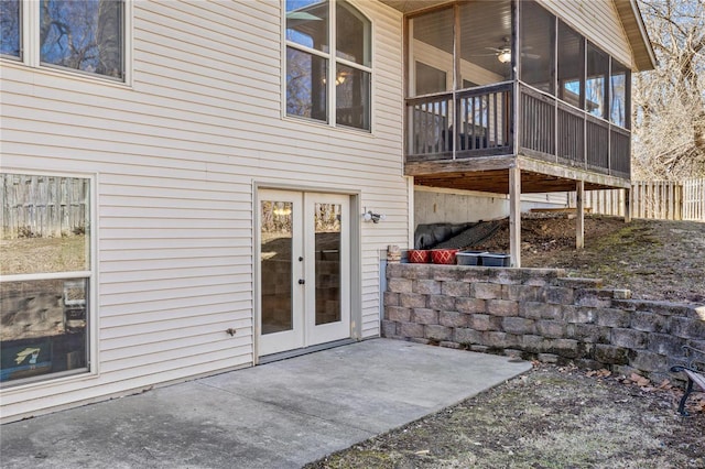 exterior space featuring a patio, french doors, fence, and a sunroom