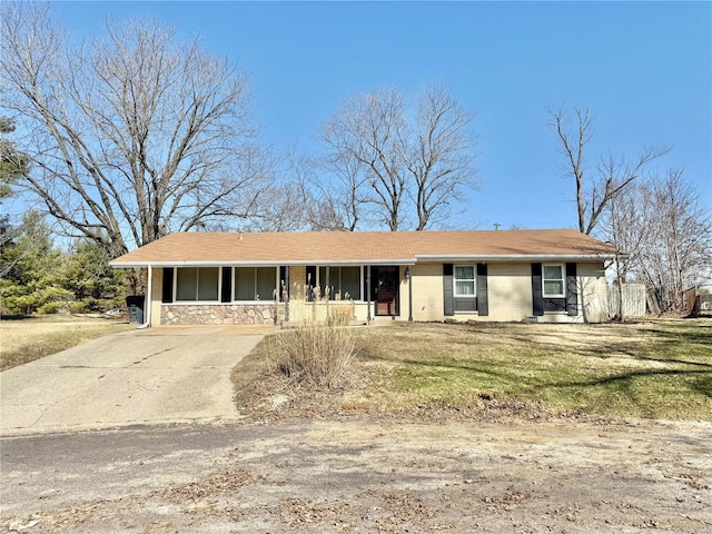 single story home featuring brick siding and driveway