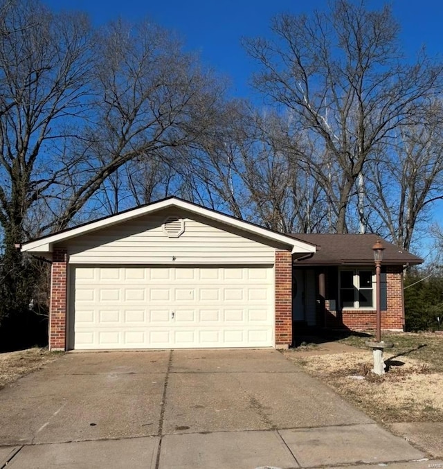 ranch-style house featuring brick siding, an attached garage, and concrete driveway