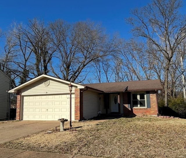 single story home with a garage, brick siding, and driveway