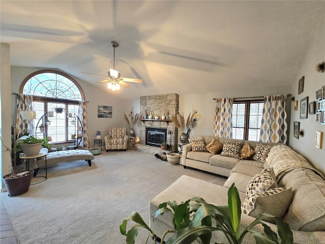 carpeted living area featuring lofted ceiling, a fireplace, and a ceiling fan