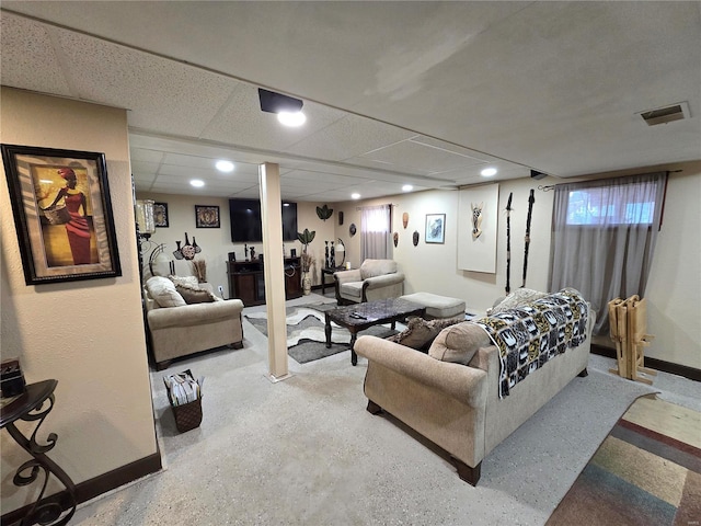 living area with visible vents, baseboards, a drop ceiling, and recessed lighting