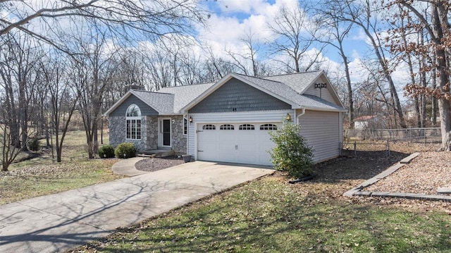 view of front of house featuring fence, driveway, an attached garage, a shingled roof, and stone siding