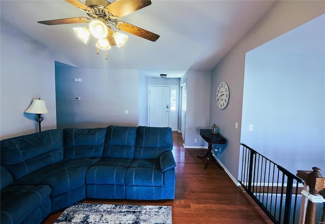 living area with baseboards and wood finished floors