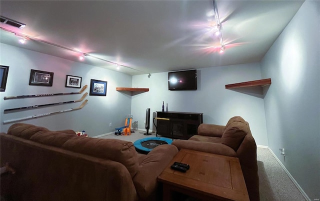 living room with visible vents, rail lighting, baseboards, and carpet floors