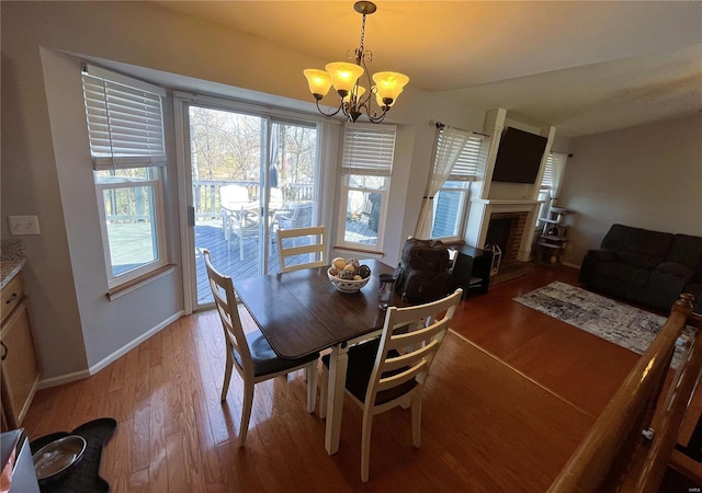 dining room featuring a wealth of natural light, a chandelier, and light wood finished floors