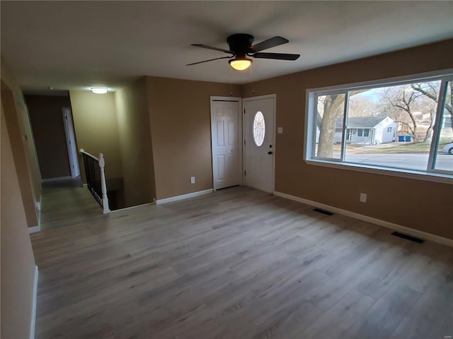 foyer entrance with visible vents, baseboards, and wood finished floors