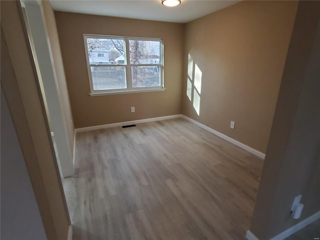 interior space with visible vents, light wood-style flooring, and baseboards