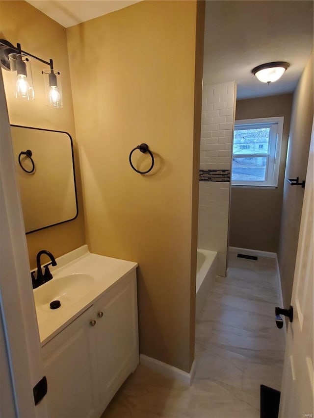 full bath with baseboards and vanity