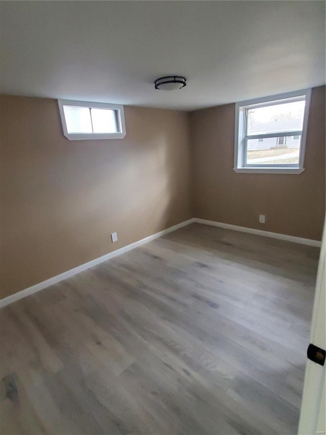 below grade area with wood finished floors and baseboards