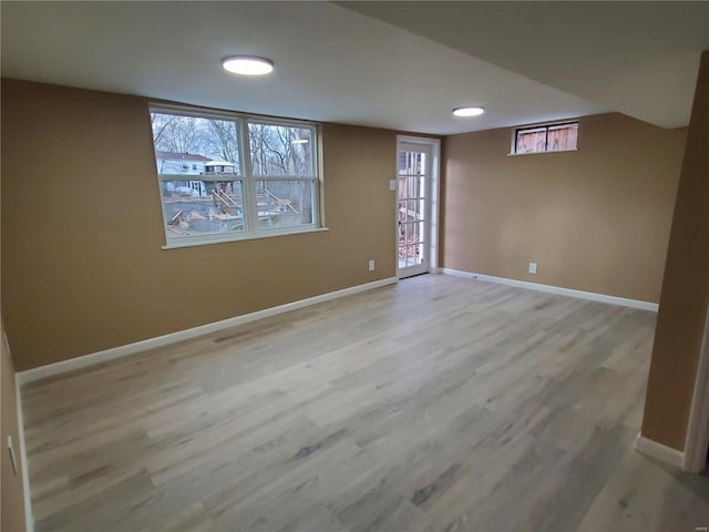 basement featuring light wood finished floors and baseboards