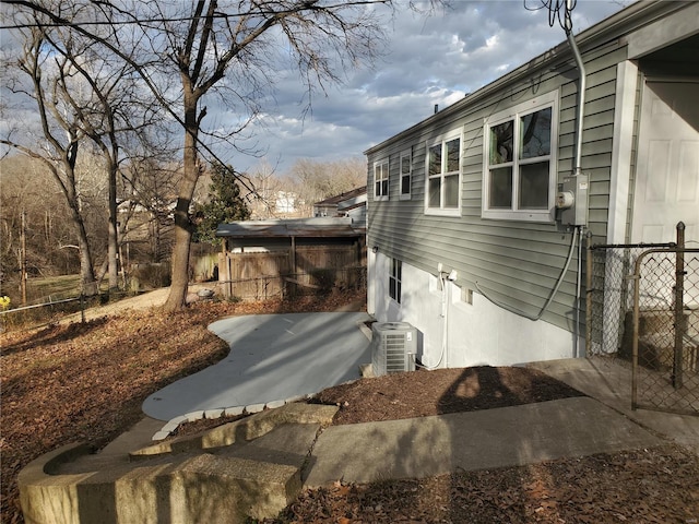 view of home's exterior with fence and central air condition unit