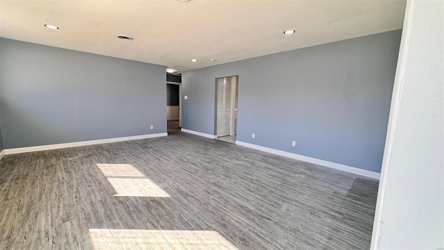 unfurnished room featuring recessed lighting, visible vents, baseboards, and wood finished floors