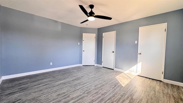 unfurnished bedroom with ceiling fan, baseboards, and wood finished floors