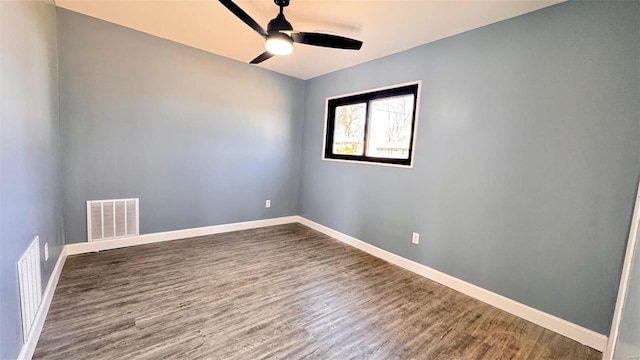 empty room with visible vents, baseboards, and wood finished floors