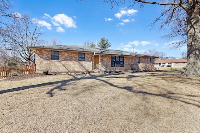 back of property with fence and brick siding